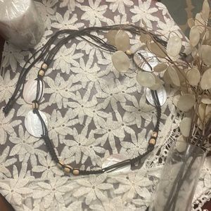 Seashell, wood bead, and brown twine necklace. Perfect condition, looks amazing.